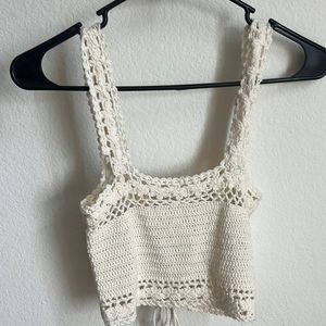 Cream colored crochet top with adjustable strings in the back